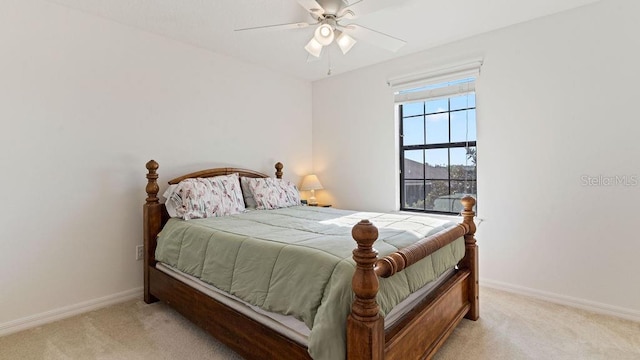 bedroom with light carpet, ceiling fan, and baseboards