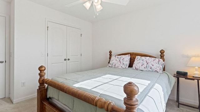 carpeted bedroom with ceiling fan, baseboards, and a closet