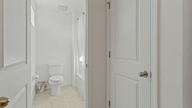 bathroom featuring toilet, baseboards, visible vents, and tile patterned floors