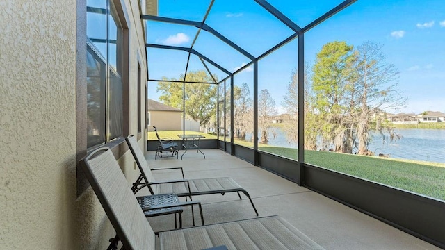 sunroom / solarium featuring a water view