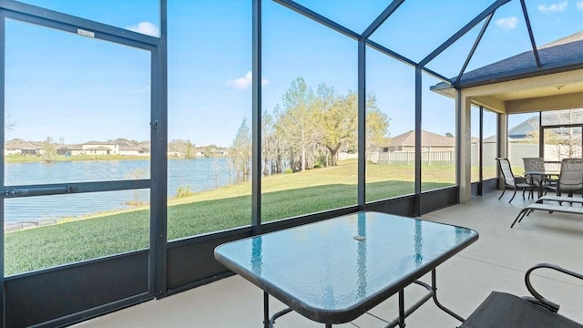 sunroom / solarium featuring a water view