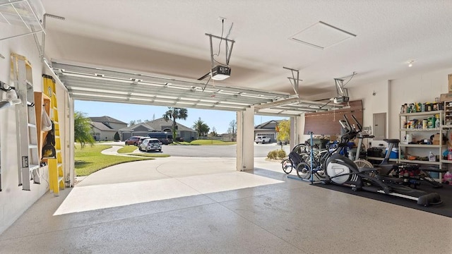 garage with electric panel and a garage door opener