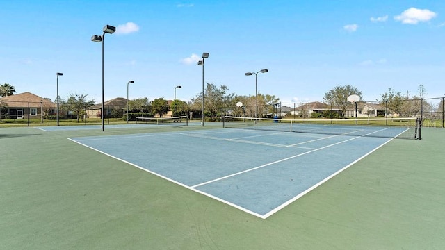 view of tennis court with fence