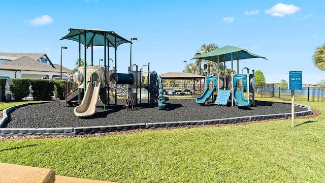 community playground featuring fence and a yard