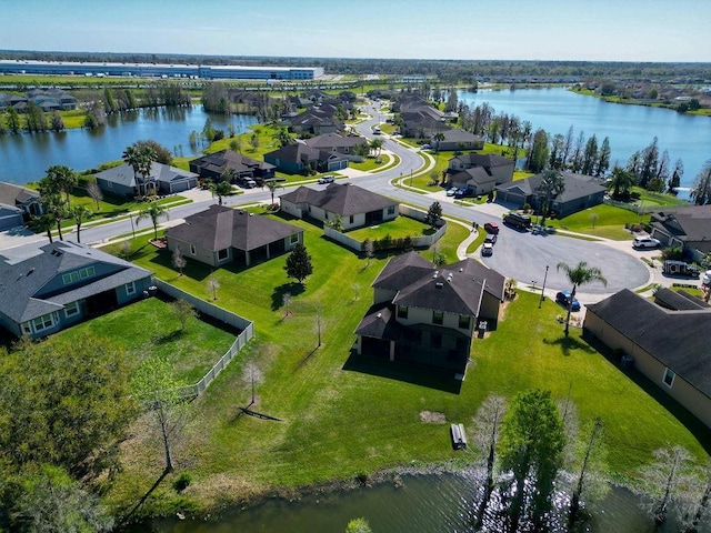 drone / aerial view featuring a water view and a residential view