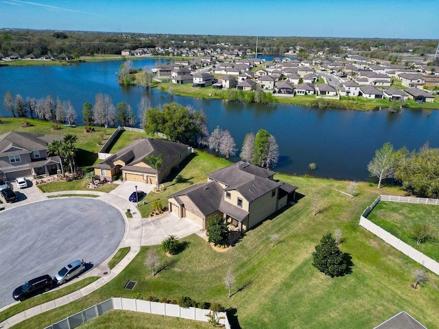 drone / aerial view featuring a water view and a residential view