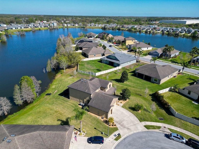 birds eye view of property with a water view and a residential view