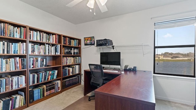 office area with carpet floors, ceiling fan, and baseboards