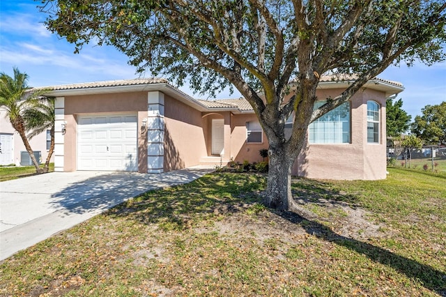 view of front facade featuring a tile roof, stucco siding, a front yard, a garage, and driveway