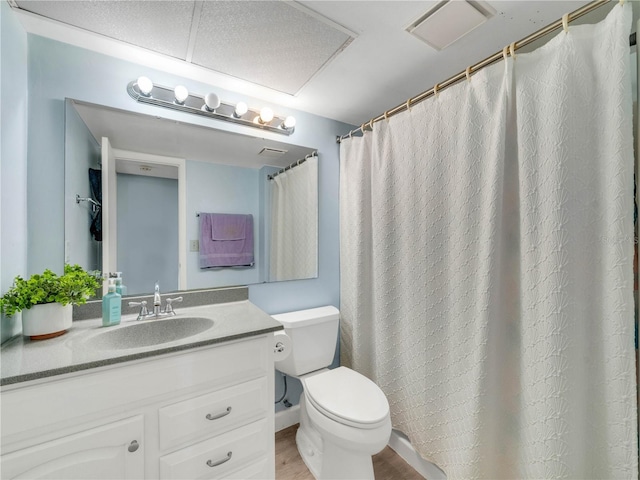 bathroom featuring visible vents, toilet, wood finished floors, and vanity