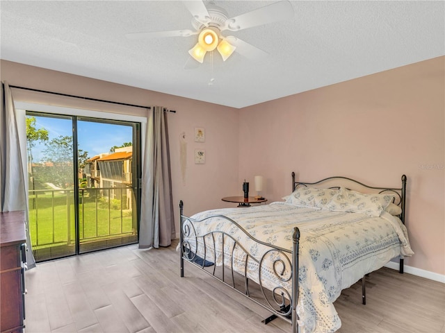 bedroom with a ceiling fan, baseboards, access to exterior, a textured ceiling, and light wood-type flooring