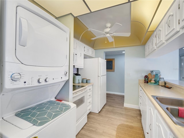 kitchen featuring stacked washer and clothes dryer, white cabinetry, light wood-style floors, and white electric range oven