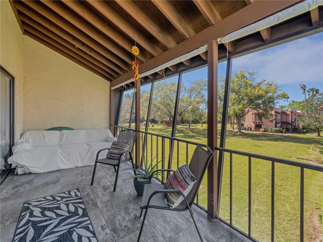 sunroom featuring lofted ceiling