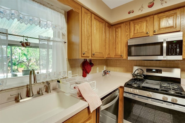 4643 1st St NW, Lakeland, FL 33810 - kitchen with a wealth of natural light, a sink, backsplash, and appliances with stainless steel finishes