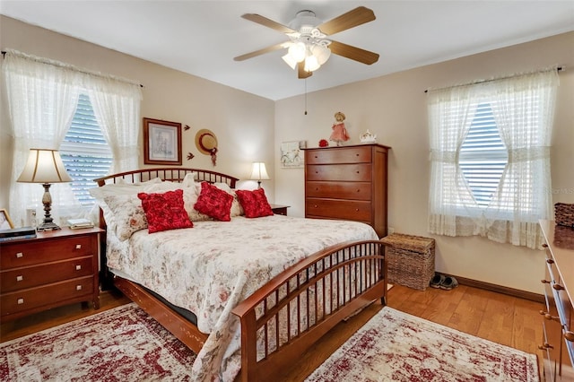 4643 1st St NW, Lakeland, FL 33810 - bedroom featuring baseboards, a ceiling fan, wood finished floors, and multiple windows