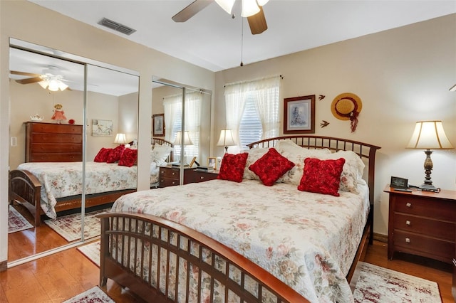 4643 1st St NW, Lakeland, FL 33810 - bedroom with wood finished floors, visible vents, two closets, and a ceiling fan