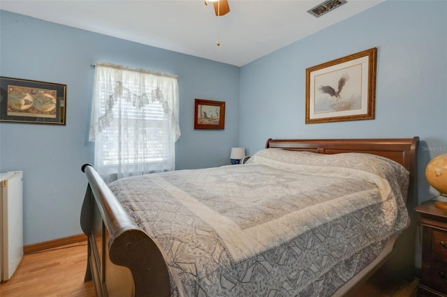 4643 1st St NW, Lakeland, FL 33810 - bedroom with light wood finished floors, baseboards, a ceiling fan, and visible vents