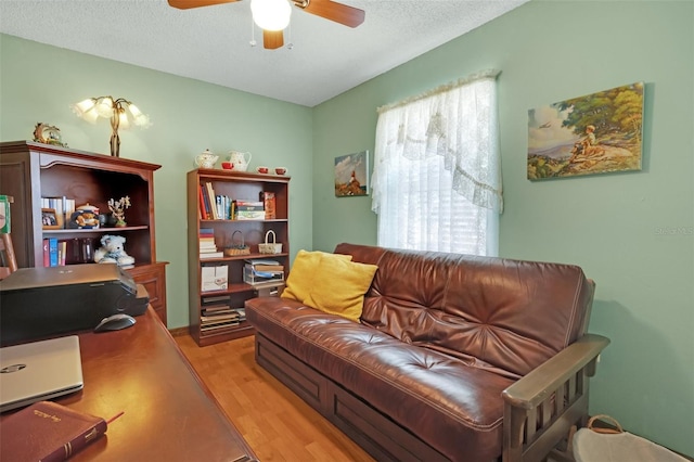 4643 1st St NW, Lakeland, FL 33810 - living area with a ceiling fan, a textured ceiling, and light wood-style floors
