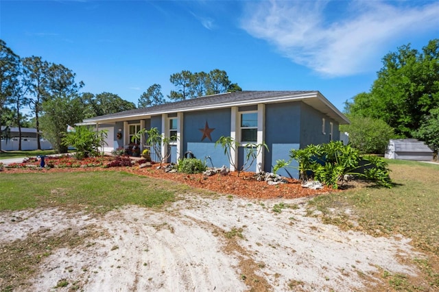 4643 1st St NW, Lakeland, FL 33810 - view of front of property with stucco siding and a front yard
