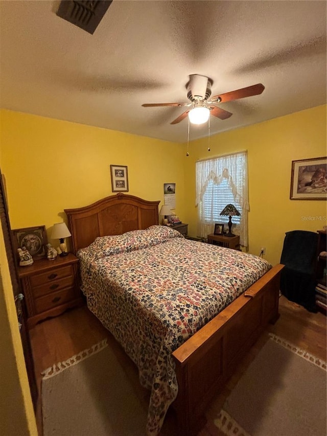 4643 1st St NW, Lakeland, FL 33810 - bedroom featuring a textured ceiling, ceiling fan, and dark wood-style flooring