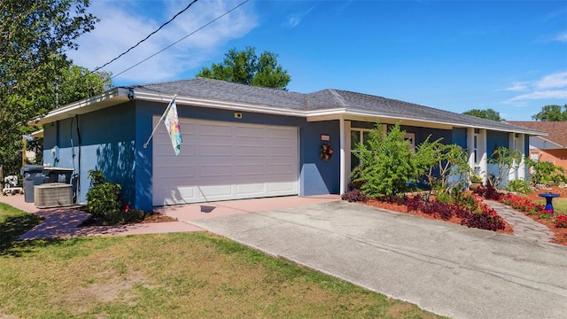 4643 1st St NW, Lakeland, FL 33810 - ranch-style home with central AC unit, a garage, concrete driveway, a front yard, and stucco siding