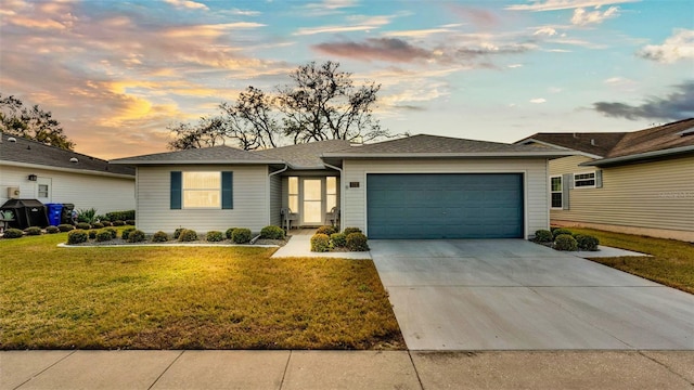 ranch-style home featuring a garage, a front yard, and concrete driveway