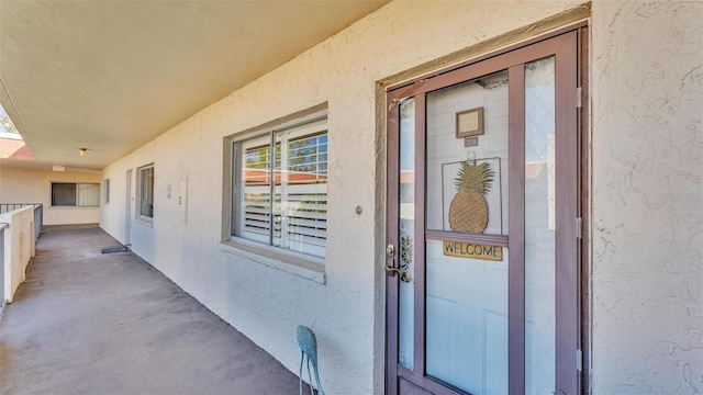 property entrance featuring stucco siding