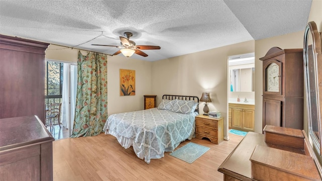 bedroom with a textured ceiling, ceiling fan, and light wood finished floors