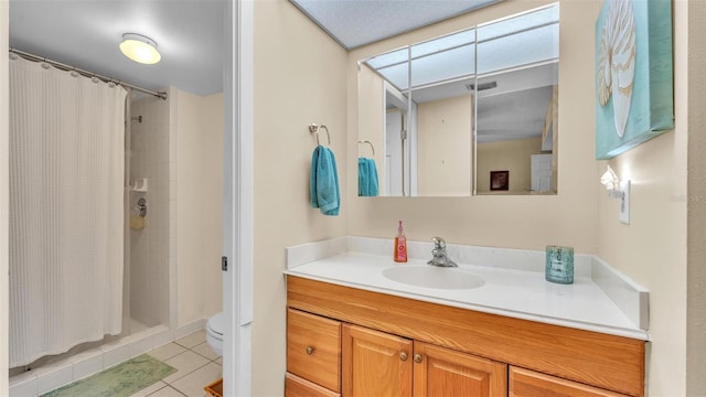 full bathroom featuring visible vents, toilet, vanity, tile patterned flooring, and tiled shower