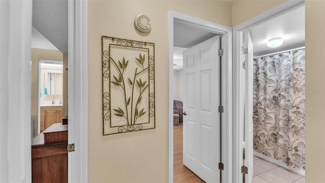 hallway featuring light tile patterned floors