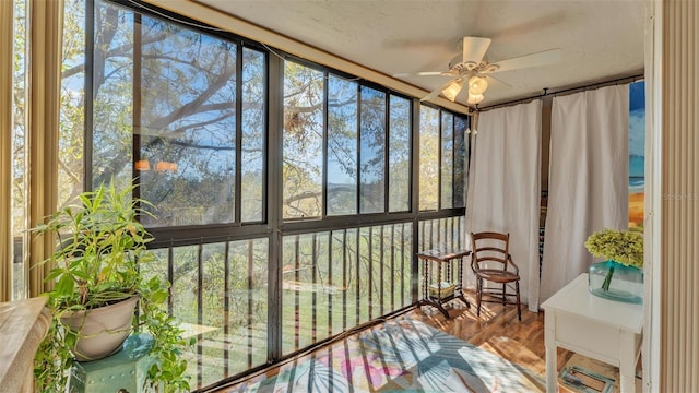 sunroom featuring ceiling fan