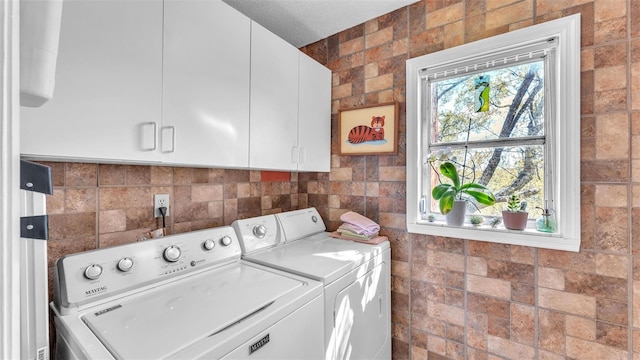 laundry room with washing machine and dryer and cabinet space