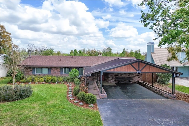 ranch-style home featuring a front lawn, aphalt driveway, and brick siding