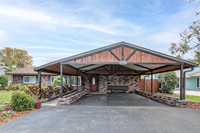 exterior space with a detached carport and driveway