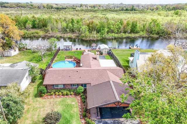 bird's eye view featuring a forest view and a water view