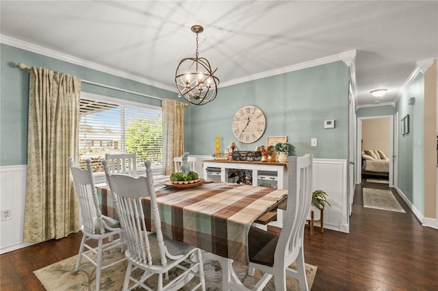 dining area with a wainscoted wall, crown molding, and wood finished floors