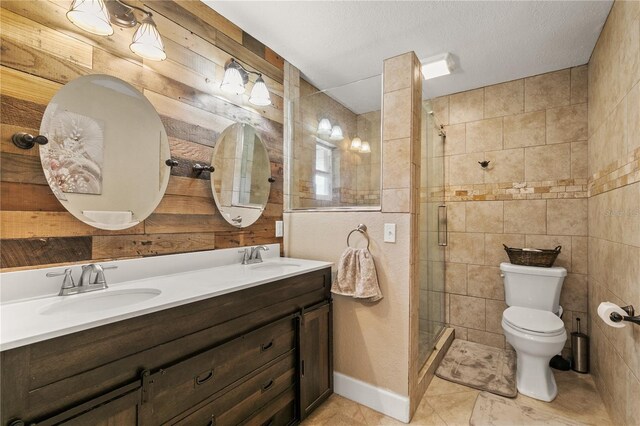 full bath with a stall shower, a sink, toilet, and double vanity