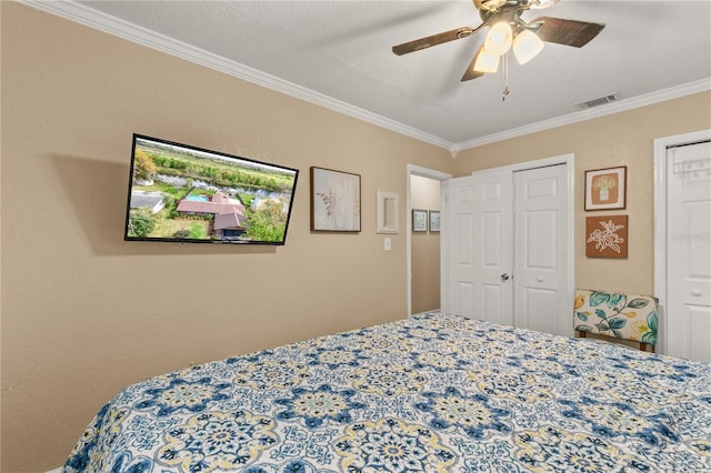 bedroom with ceiling fan, visible vents, and crown molding