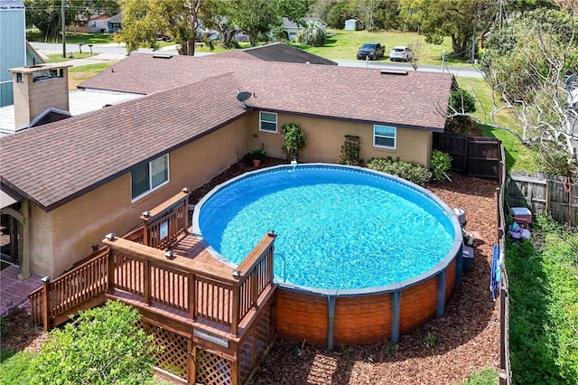 view of pool with a fenced in pool, fence, and a deck