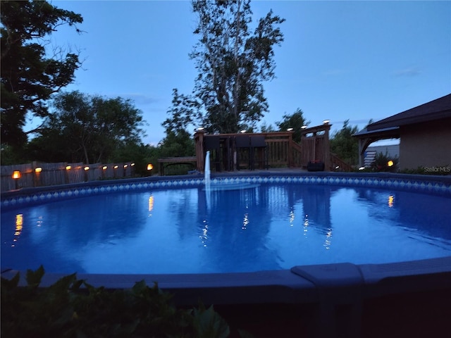 view of swimming pool with a fenced in pool