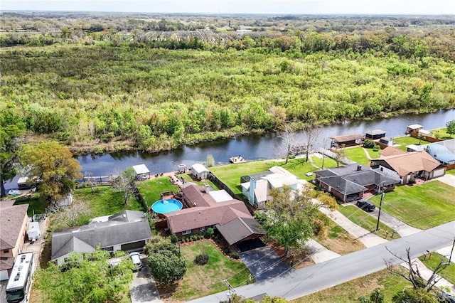 aerial view with a water view, a wooded view, and a residential view