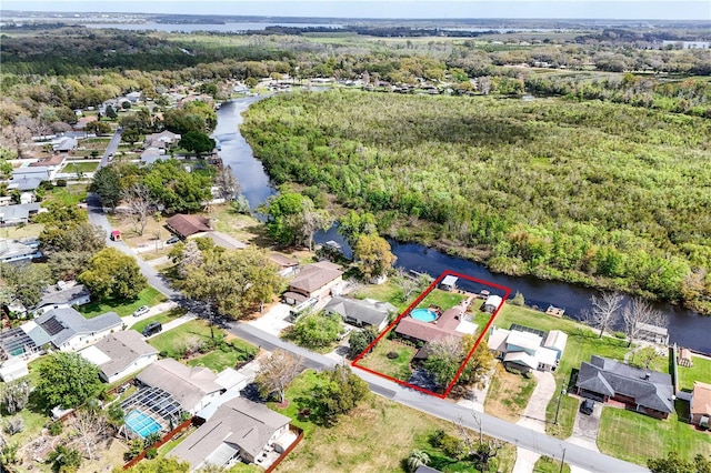 aerial view featuring a residential view, a water view, and a wooded view