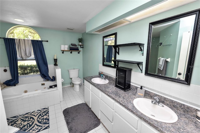 full bath with toilet, a tub with jets, visible vents, and a sink