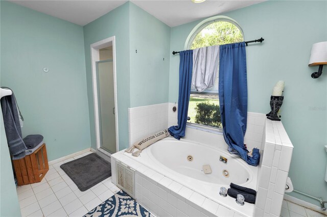 full bathroom with a shower stall, a whirlpool tub, and tile patterned floors