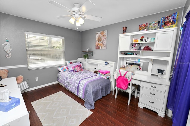 bedroom featuring ceiling fan, baseboards, and wood finished floors