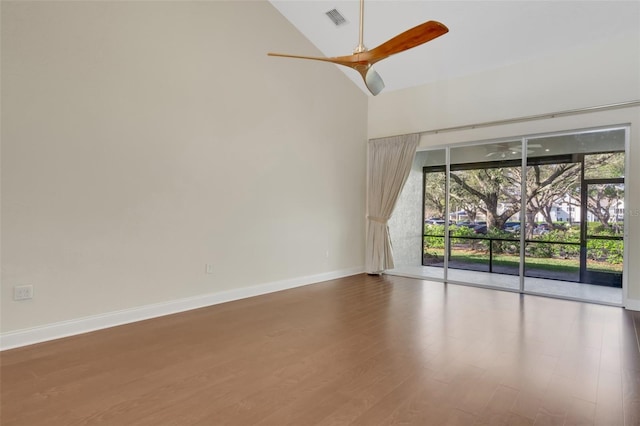 empty room featuring a healthy amount of sunlight, baseboards, visible vents, and wood finished floors