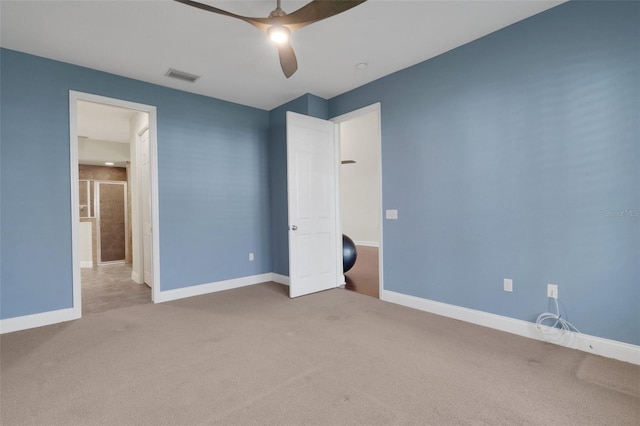 unfurnished bedroom with carpet floors, baseboards, visible vents, and a ceiling fan