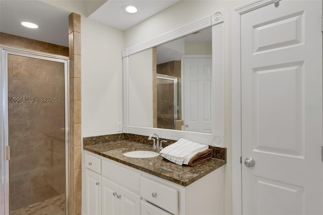 bathroom featuring a stall shower, recessed lighting, and vanity