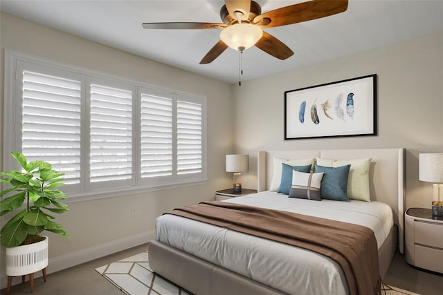 bedroom with a ceiling fan and baseboards