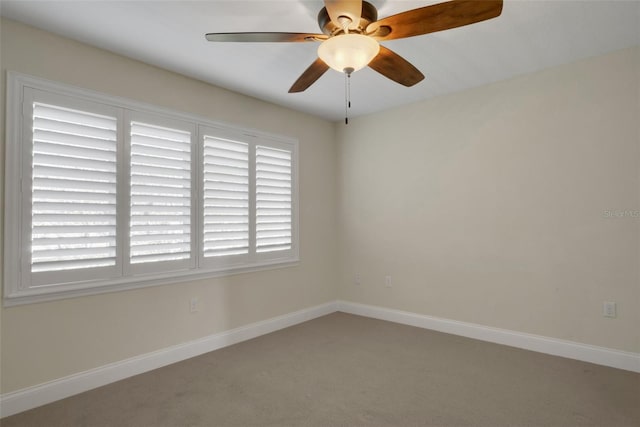 unfurnished room featuring ceiling fan, a wealth of natural light, and baseboards